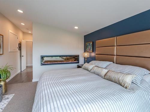 1122 Redlands Road, Penticton, BC - Indoor Photo Showing Bedroom With Fireplace