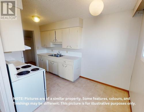 105 9807 104 Avenue, Fort St. John, BC - Indoor Photo Showing Kitchen With Double Sink