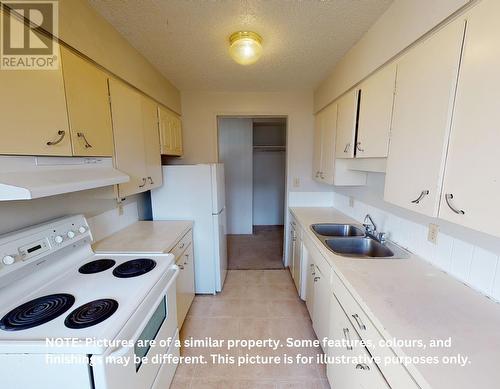 105 9807 104 Avenue, Fort St. John, BC - Indoor Photo Showing Kitchen With Double Sink