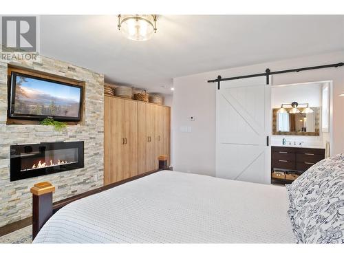 855 Rumney Road, West Kelowna, BC - Indoor Photo Showing Bedroom With Fireplace