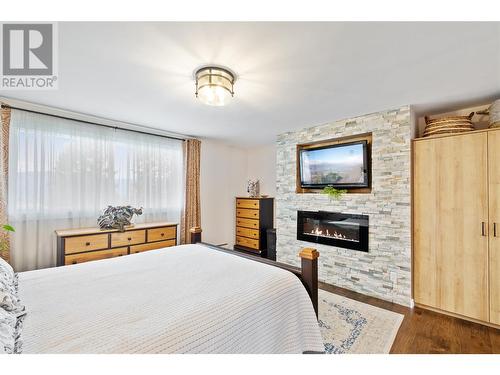 855 Rumney Road, West Kelowna, BC - Indoor Photo Showing Bedroom With Fireplace