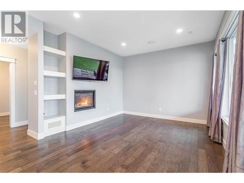 1288 Steele Road, Kelowna, BC - Indoor Photo Showing Other Room With Fireplace