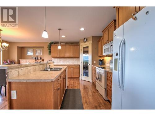 6472 Agassiz Road, Vernon, BC - Indoor Photo Showing Kitchen With Fireplace