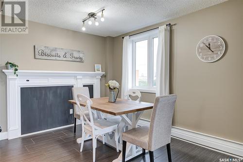 903 320 5Th Avenue N, Saskatoon, SK - Indoor Photo Showing Dining Room With Fireplace