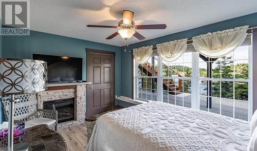 14 Church Road, Pilley'S Island, NL - Indoor Photo Showing Bedroom With Fireplace