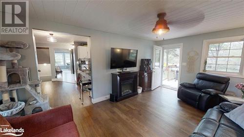 Walk out to deck from Living Room - 639 Ravenscliffe Road, Huntsville, ON - Indoor Photo Showing Living Room With Fireplace