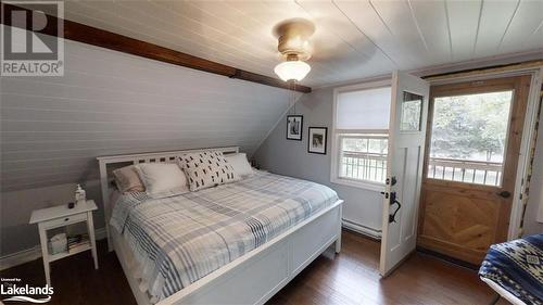 Primary Bedroom with walk out to Balcony - 639 Ravenscliffe Road, Huntsville, ON - Indoor Photo Showing Bedroom