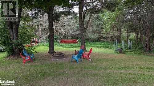 Beautiful grounds with firepit - 639 Ravenscliffe Road, Huntsville, ON - Outdoor With Backyard