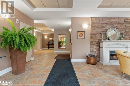 Main entrance/lobby - 130 Steamship Bay Road Unit# 305, Gravenhurst, ON - Indoor Photo Showing Other Room With Fireplace
