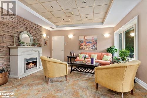 Main lobby - 130 Steamship Bay Road Unit# 305, Gravenhurst, ON - Indoor Photo Showing Living Room With Fireplace