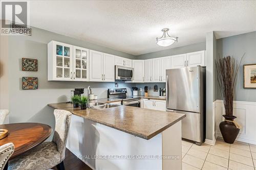 324 - 2030 Cleaver Avenue, Burlington, ON - Indoor Photo Showing Kitchen With Double Sink