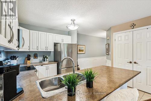 324 - 2030 Cleaver Avenue, Burlington, ON - Indoor Photo Showing Kitchen With Double Sink