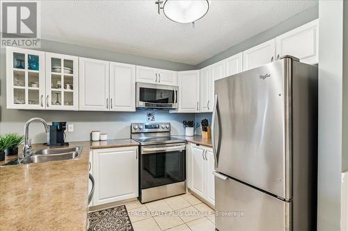 324 - 2030 Cleaver Avenue, Burlington, ON - Indoor Photo Showing Kitchen With Stainless Steel Kitchen With Double Sink