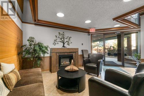 1056 Bernard Avenue Unit# 205, Kelowna, BC - Indoor Photo Showing Living Room With Fireplace