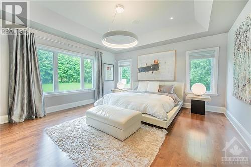 Primary bedroom retreat flooded with natural light. Enjoy music on your integrated speaker system and features two walk-in closets. - 6163 Pebblewoods Drive, Ottawa, ON - Indoor Photo Showing Bedroom