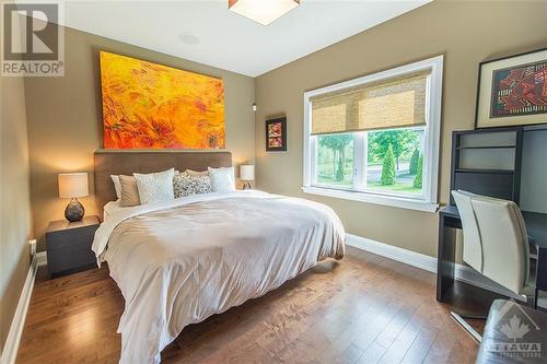 Both secondary rooms boast bright windows, hardwood flooring, and integrated speakers with separate controls. - 6163 Pebblewoods Drive, Ottawa, ON - Indoor Photo Showing Bedroom