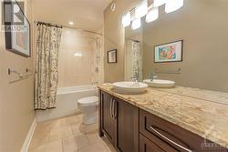Family bathroom located between the two secondary bedrooms, features a spacious vanity, granite counters & soaker tub. - 
