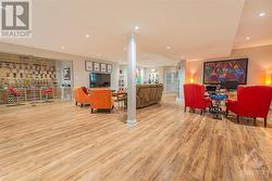 The lower level,  complete with dimmable pot lighting, laminate flooring features a tempered glass enclosed hobby room, recreation room and second home office space was professionally finished in - 