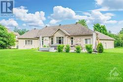 Rear elevation of this spacious bungalow, backing onto the 3rd hole of Emerald Links Golf & Country Club is  bordered by lush trees for privacy. - 