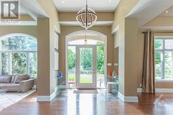 a oversized A contemporary glass front door with sidelights and an arched transom window welcomes you into the home. - 