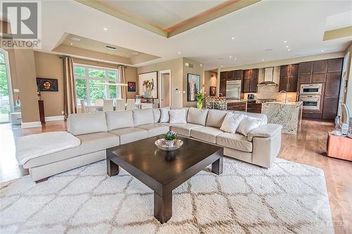 As you step into this magnificent open-concept home, with birch hardwood floors and 13' ceiling. - 6163 Pebblewoods Drive, Ottawa, ON - Indoor Photo Showing Living Room