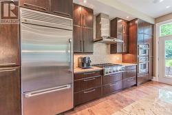 The kitchen's sleek and modern aesthetic is further enhanced by GE Monogram stainless steel appliances. - 