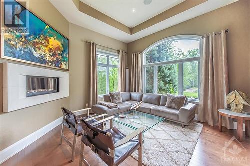 Cozy up with a book or enjoy your morning coffee in the separate living room complete with a separate gas fireplace for your seasonal enjoyment. This space is located in a quiet corner at the fron - 6163 Pebblewoods Drive, Ottawa, ON - Indoor Photo Showing Living Room