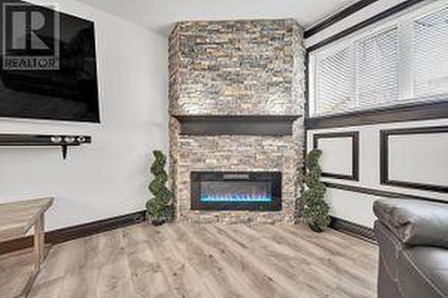 113 - 120 Bell Farm Road, Barrie, ON - Indoor Photo Showing Living Room With Fireplace