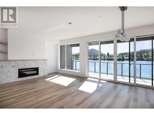 2735 Shannon Lake Road Unit# 101, West Kelowna, BC - Indoor With Fireplace With Body Of Water