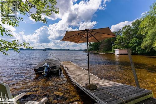 Private dock on Fairy Lake - 222 Golden Pheasant Drive, Huntsville, ON - Outdoor With Body Of Water