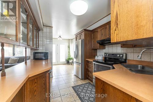 69 Lord Simcoe Drive, Brampton, ON - Indoor Photo Showing Kitchen With Fireplace With Double Sink
