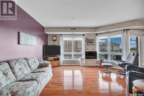 506 902 Spadina Crescent E, Saskatoon, SK - Indoor Photo Showing Living Room With Fireplace