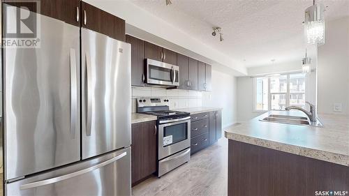 305 5303 Universal Crescent, Regina, SK - Indoor Photo Showing Kitchen With Stainless Steel Kitchen With Double Sink