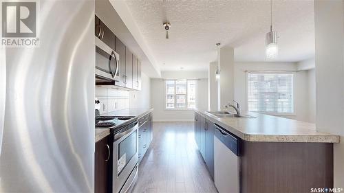 305 5303 Universal Crescent, Regina, SK - Indoor Photo Showing Kitchen With Stainless Steel Kitchen With Upgraded Kitchen