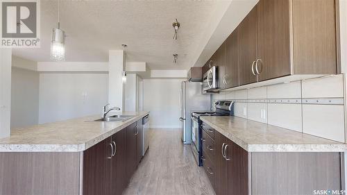 305 5303 Universal Crescent, Regina, SK - Indoor Photo Showing Kitchen With Double Sink