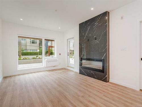 202-654 Granderson Rd, Langford, BC - Indoor Photo Showing Living Room With Fireplace