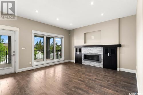 27 College Crescent, White City, SK - Indoor Photo Showing Living Room With Fireplace