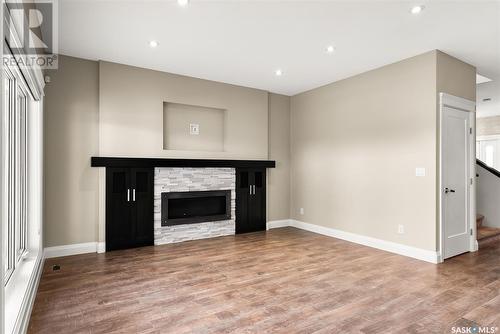 27 College Crescent, White City, SK - Indoor Photo Showing Other Room With Fireplace