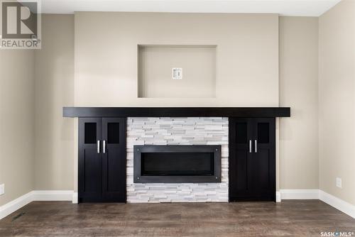 27 College Crescent, White City, SK - Indoor Photo Showing Living Room With Fireplace