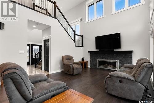 22 Aspen Village Drive, Emerald Park, SK - Indoor Photo Showing Living Room With Fireplace