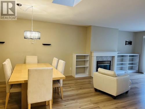 31 500 Wotzke Drive, Williams Lake, BC - Indoor Photo Showing Dining Room With Fireplace