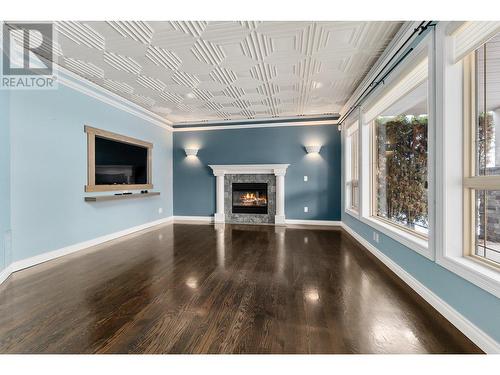 3937 Gallaghers Circle, Kelowna, BC - Indoor Photo Showing Other Room With Fireplace