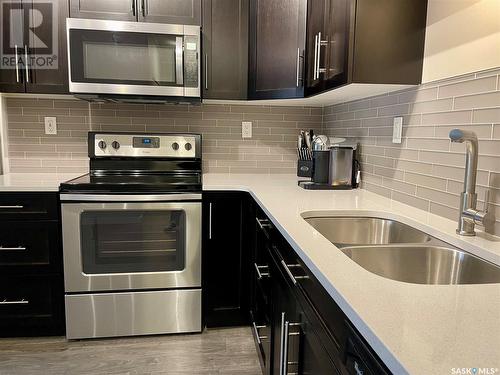 203 720 Baltzan Boulevard, Saskatoon, SK - Indoor Photo Showing Kitchen With Stainless Steel Kitchen With Double Sink With Upgraded Kitchen