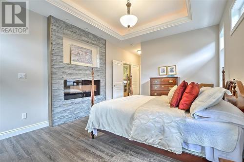 21 Lukas, Kingsville, ON - Indoor Photo Showing Bedroom With Fireplace