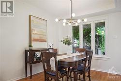 The inviting dining area features a contemporary light fixture. - 