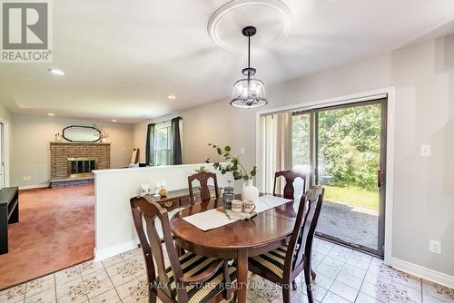 15 Don Court, Kawartha Lakes, ON - Indoor Photo Showing Dining Room With Fireplace