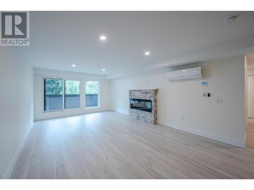 217 Elm Avenue Unit# 207, Penticton, BC - Indoor Photo Showing Living Room With Fireplace