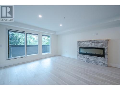 217 Elm Avenue Unit# 207, Penticton, BC - Indoor Photo Showing Living Room With Fireplace