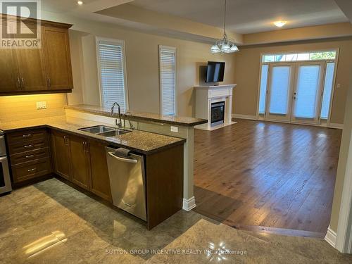 14 - 11 Vista Gardens, New Tecumseth, ON - Indoor Photo Showing Kitchen With Fireplace With Double Sink