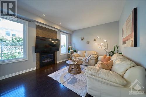 Open-concept main floor that features 9 ft ceilings, hardwood floors, and a cozy gas fireplace in the family room. - 540 Dundonald Drive, Ottawa, ON - Indoor Photo Showing Living Room